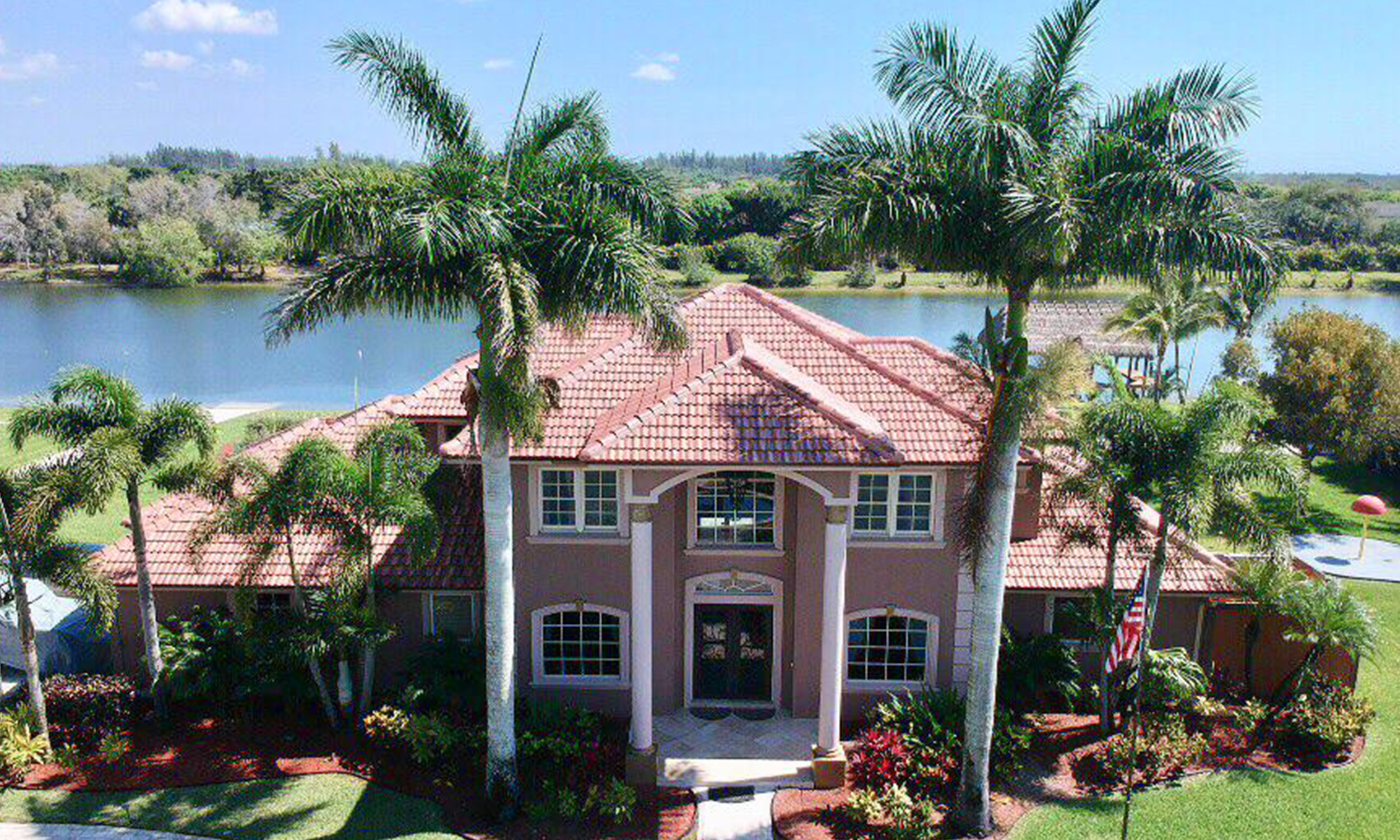 residential house by the water with a multi tiered new barrel roof